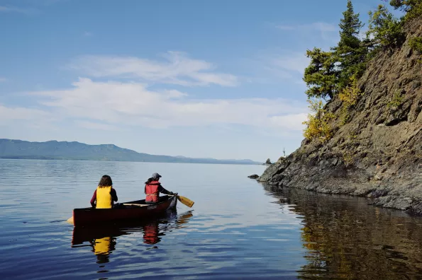 two people in a canoe on a lake