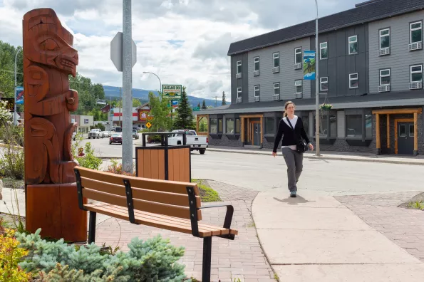 A person walking through downtown Burns Lake.