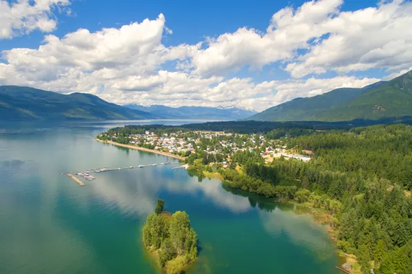 An aerial view of a town on the edge of a large lake 