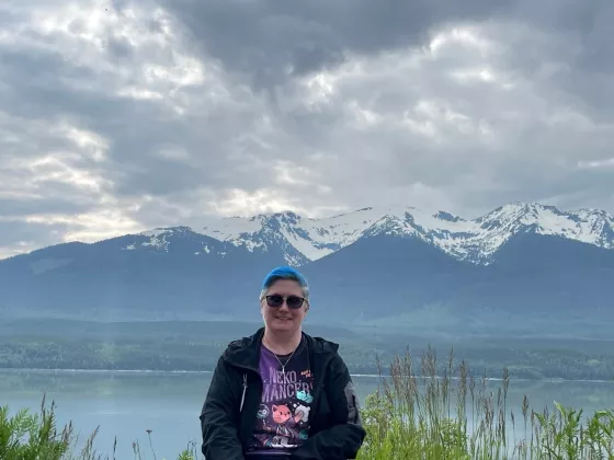 image of Nicole in front of scenic view of mountain with water