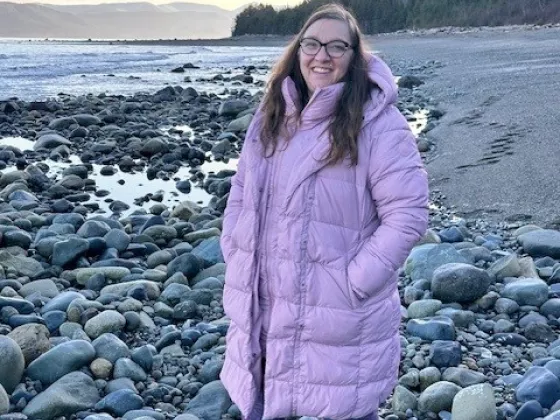 Jill standing on a rocky ocean shore front