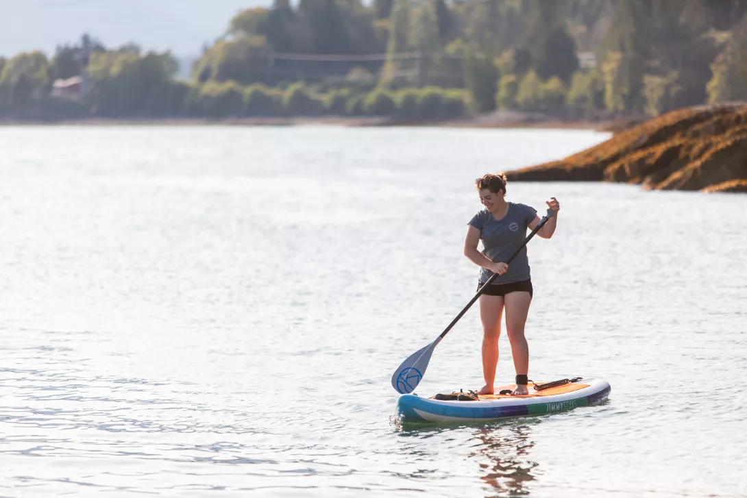 image of woman paddle boarding